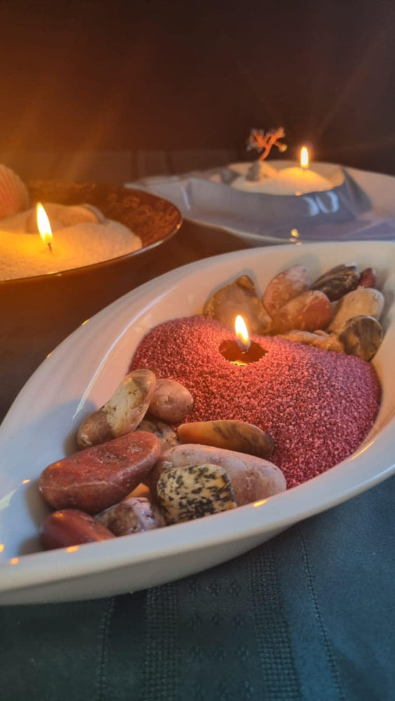 wine red lumizen candle sand burning with river rocks display